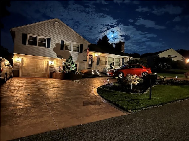 split level home featuring a garage and concrete driveway