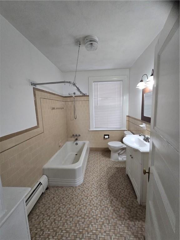 full bath featuring a baseboard radiator, shower / washtub combination, tile walls, and vanity