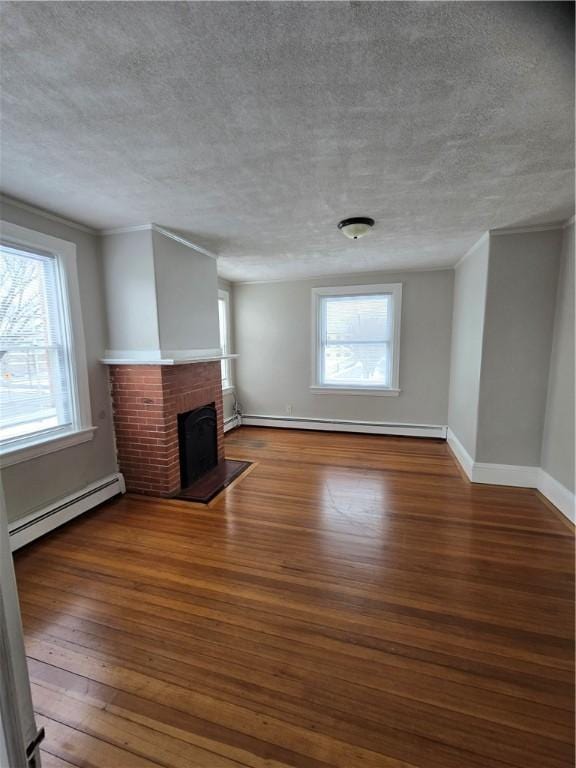 unfurnished living room featuring dark wood-style floors, baseboards, a fireplace, and a baseboard heating unit