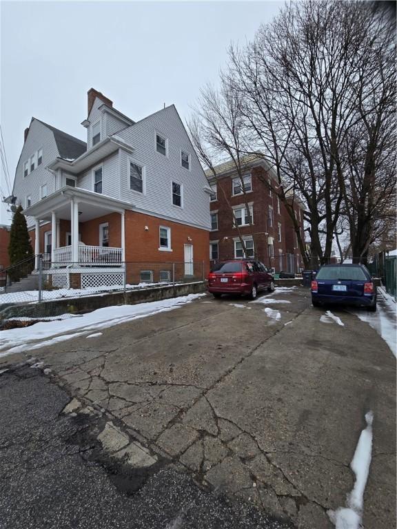 view of side of property featuring covered porch