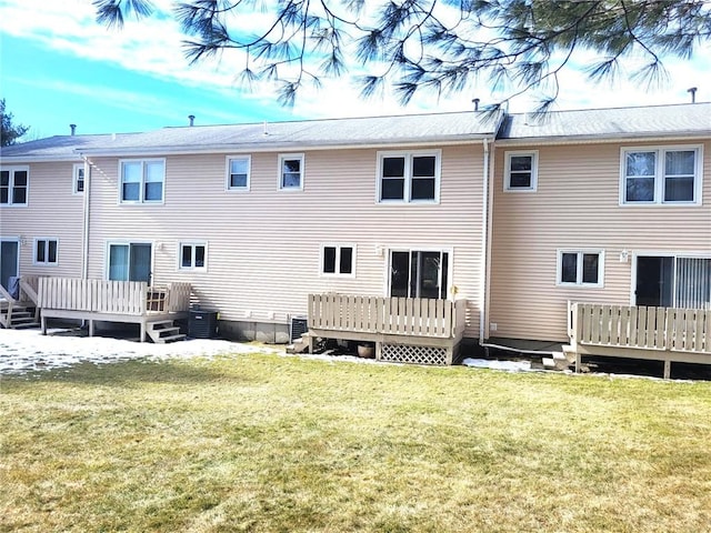 rear view of property featuring a deck, a yard, and central air condition unit