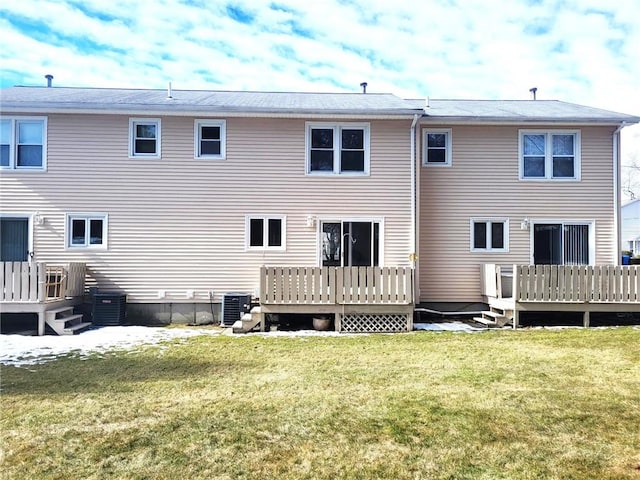 back of house featuring a lawn, a deck, and central air condition unit