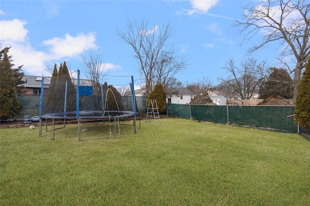 view of yard with a fenced backyard and a trampoline