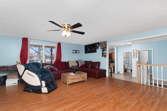 living area with a ceiling fan and light wood-style floors