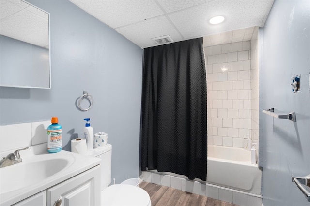 full bathroom featuring visible vents, toilet, shower / tub combo, vanity, and wood finished floors