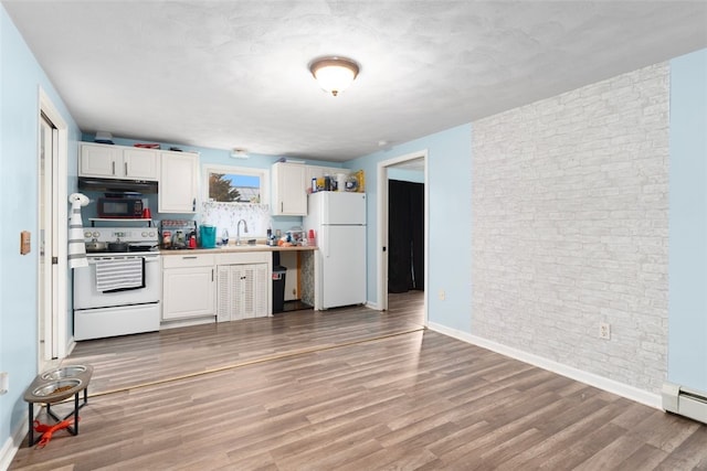 kitchen featuring white appliances, baseboards, white cabinets, brick wall, and light wood-type flooring