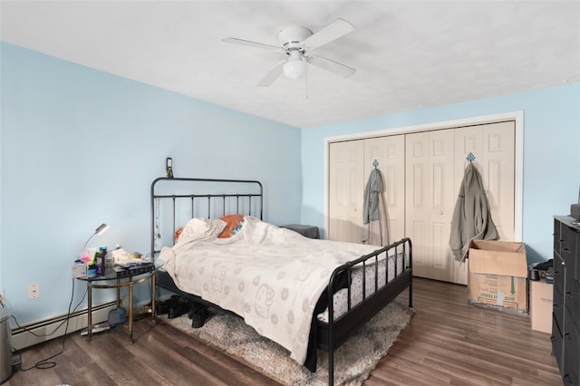 bedroom with ceiling fan, a closet, a baseboard radiator, and wood finished floors