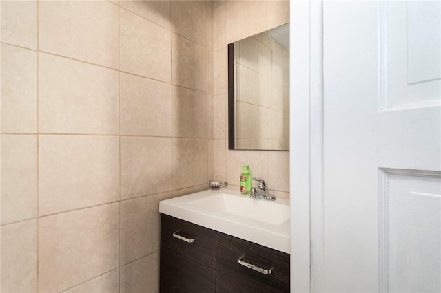 bathroom with tile walls and vanity