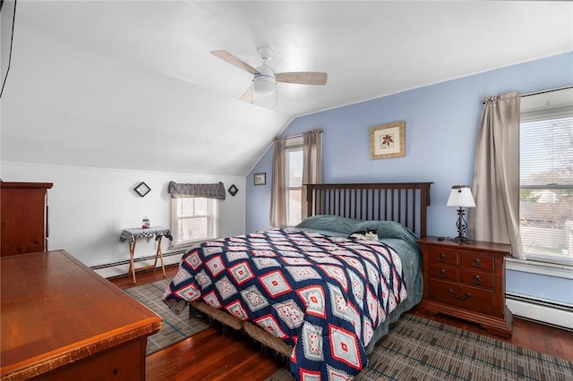 bedroom with dark wood-type flooring, a baseboard radiator, and multiple windows