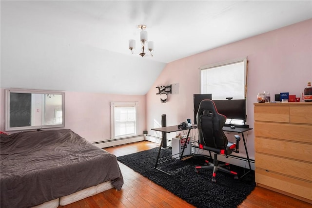 bedroom with a baseboard heating unit, vaulted ceiling, wood finished floors, and a chandelier