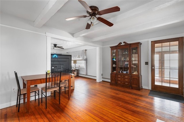 dining space with dark wood-style flooring, a baseboard radiator, beam ceiling, and baseboards