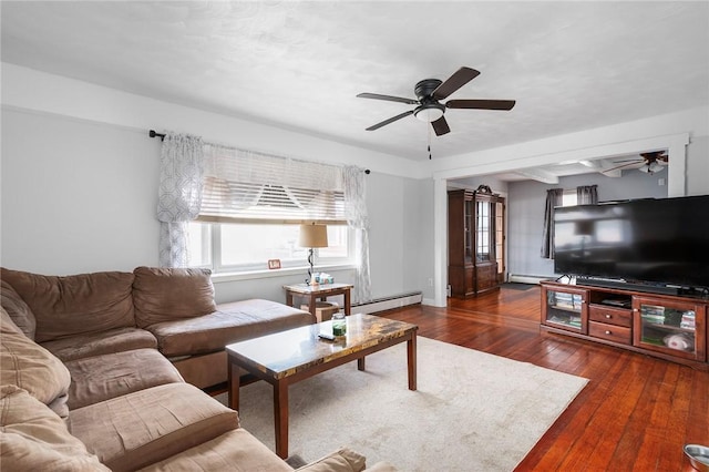 living area with dark wood-type flooring, a baseboard heating unit, and ceiling fan