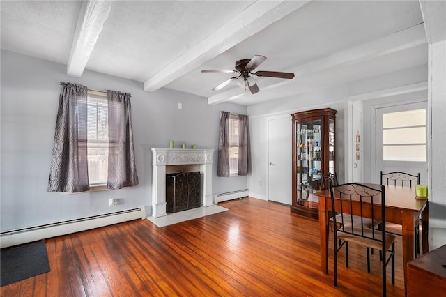 unfurnished living room featuring wood finished floors, a baseboard radiator, a fireplace with flush hearth, and beam ceiling