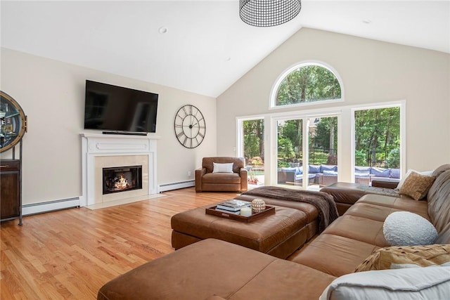 living area featuring high vaulted ceiling, a baseboard radiator, a fireplace with flush hearth, and light wood-style flooring