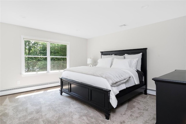 bedroom with a baseboard radiator, light carpet, and visible vents