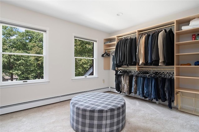 spacious closet featuring a baseboard heating unit and light colored carpet