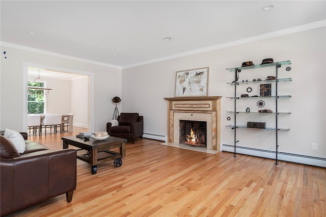 living area featuring light wood finished floors, a fireplace with flush hearth, ornamental molding, and a baseboard heating unit