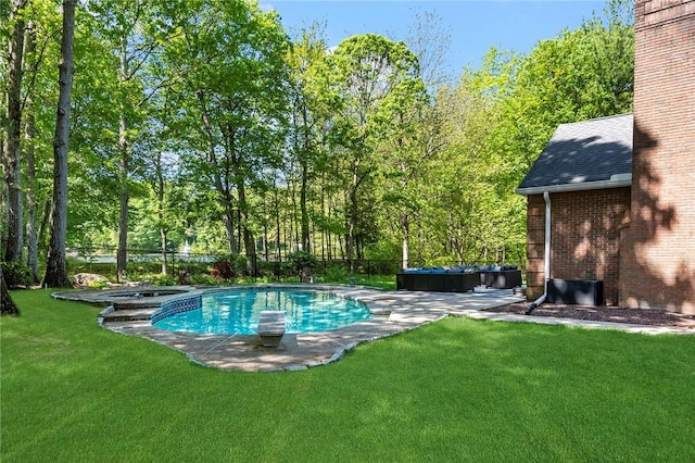 outdoor pool with a diving board, a jacuzzi, a patio, and a lawn