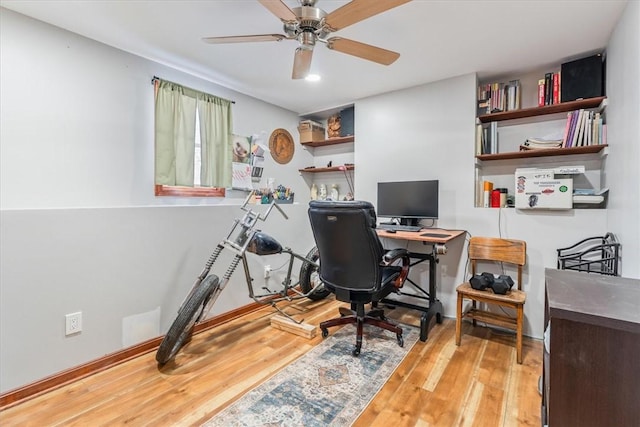 office with light wood finished floors, baseboards, and a ceiling fan