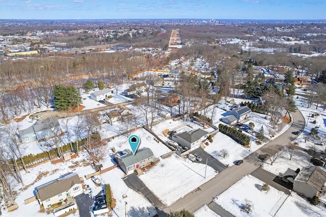 snowy aerial view with a residential view