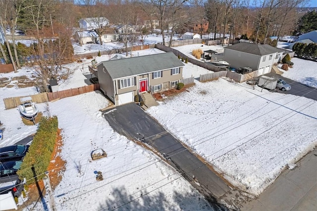 snowy aerial view with a residential view