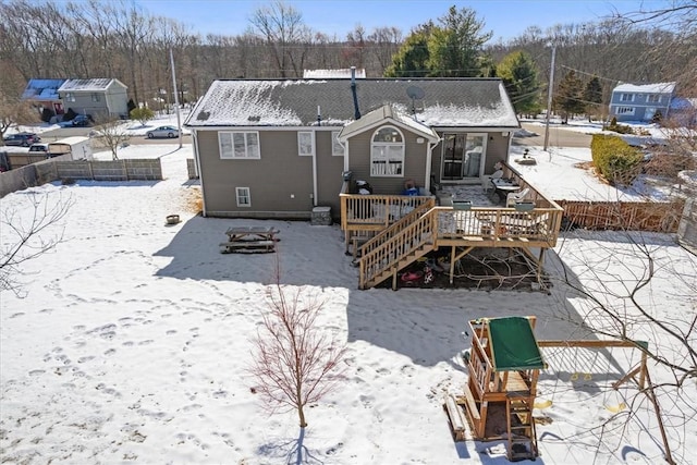 snow covered property featuring a wooden deck and stairs