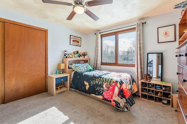 bedroom with ceiling fan and light colored carpet