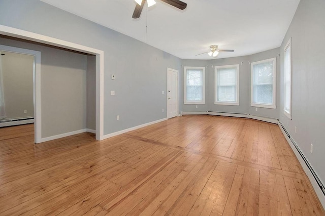 unfurnished room featuring a baseboard heating unit, ceiling fan, light wood-style flooring, and baseboards