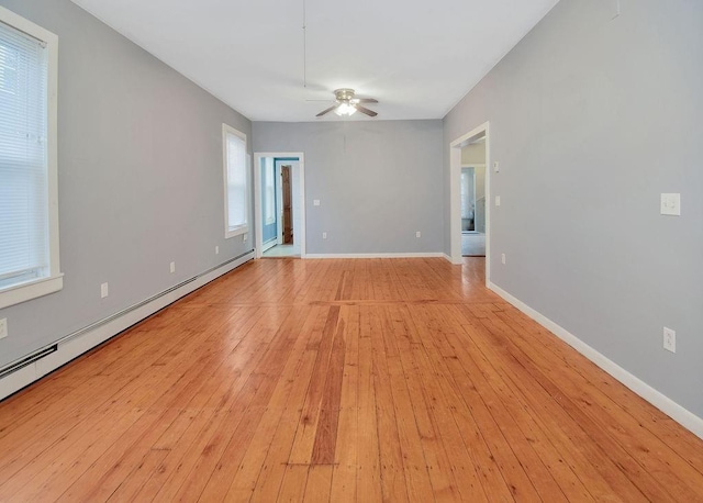 empty room with a ceiling fan, a baseboard radiator, light wood-style flooring, and baseboards