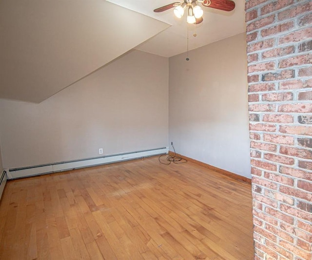 empty room with light wood-style floors, baseboards, a baseboard heating unit, and a ceiling fan