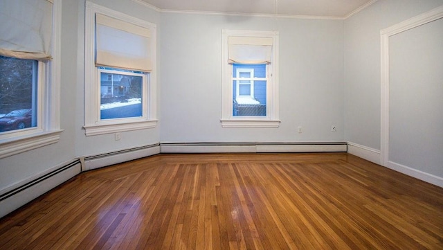 unfurnished room featuring crown molding, baseboards, and wood finished floors