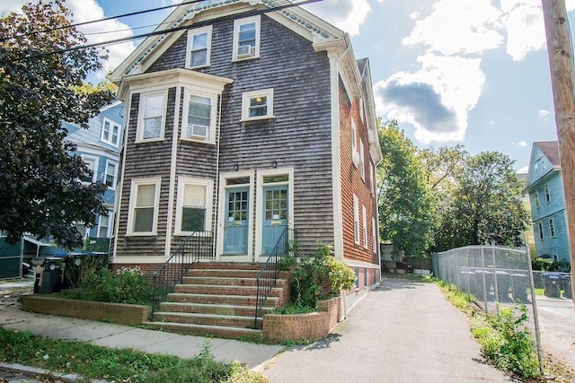 view of front of home featuring fence