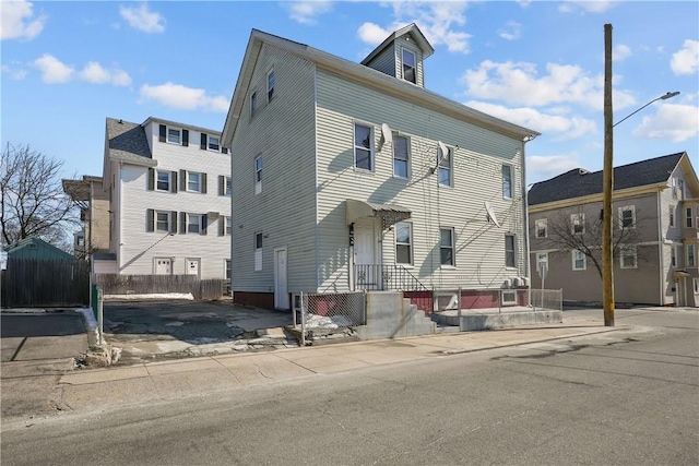 view of front of home featuring fence