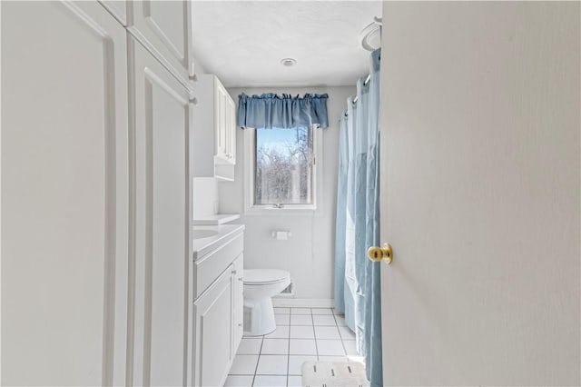 bathroom with shower / tub combo, toilet, vanity, and tile patterned flooring