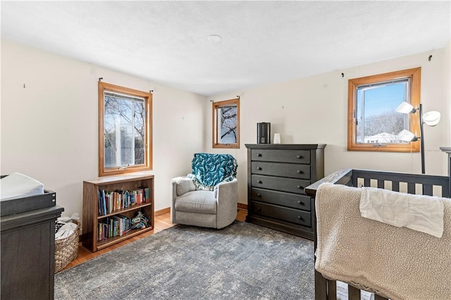 bedroom with baseboards and wood finished floors