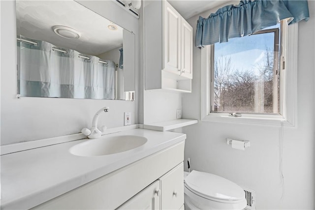 bathroom featuring a shower with curtain, toilet, and vanity