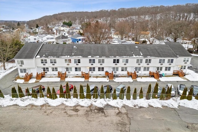 snowy aerial view with a residential view