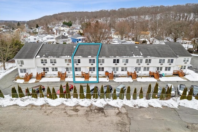 snowy aerial view featuring a residential view