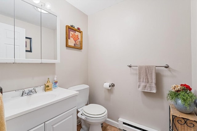 half bathroom featuring baseboard heating, baseboards, vanity, and toilet