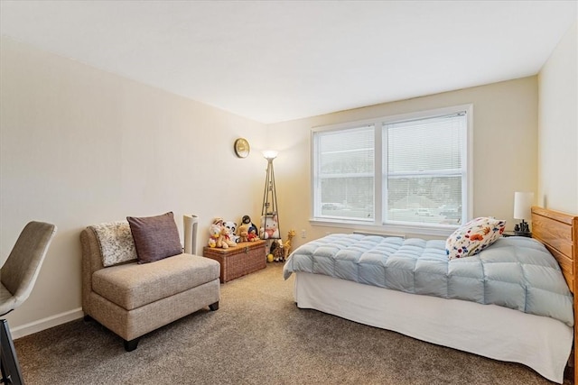 bedroom featuring carpet and baseboards