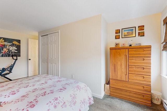 bedroom featuring carpet floors, baseboard heating, a closet, and baseboards