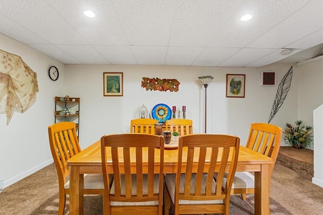 carpeted dining space with recessed lighting, a drop ceiling, and baseboards