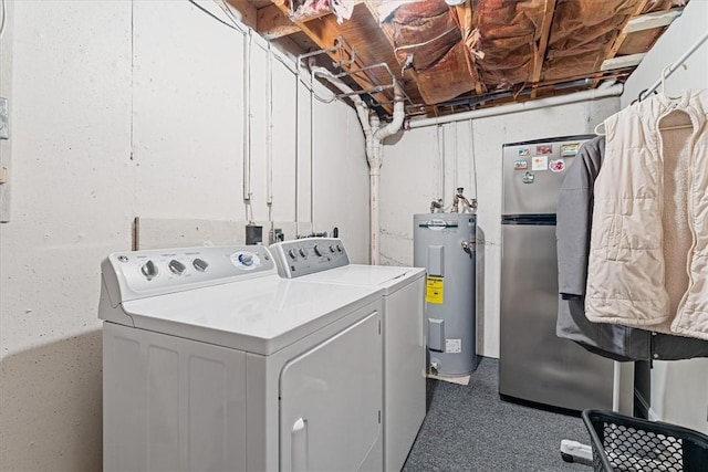 washroom featuring washing machine and dryer, laundry area, and water heater