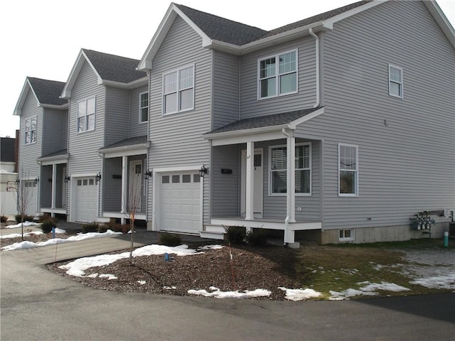 view of front facade featuring an attached garage and covered porch