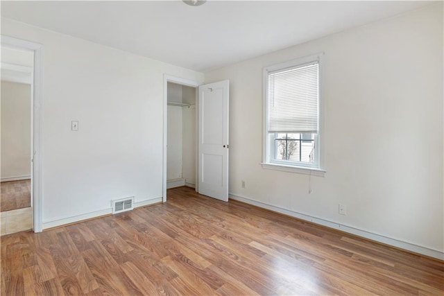 unfurnished bedroom featuring visible vents and light wood finished floors