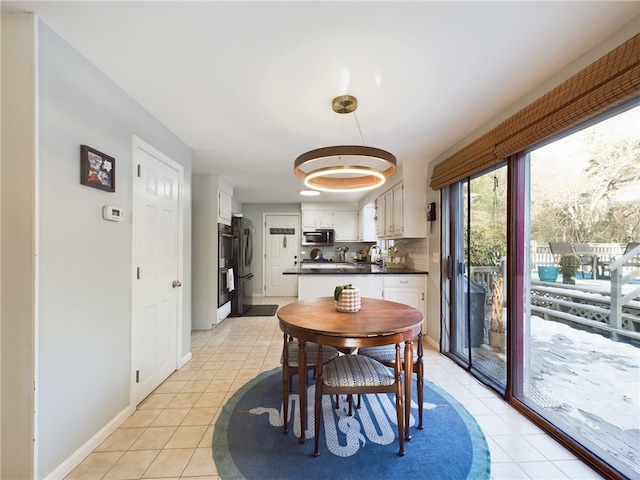 dining area featuring baseboards and light tile patterned floors