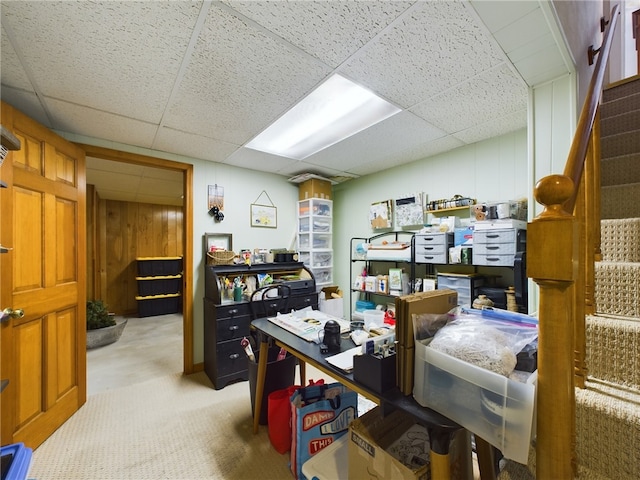 office with wooden walls and a drop ceiling