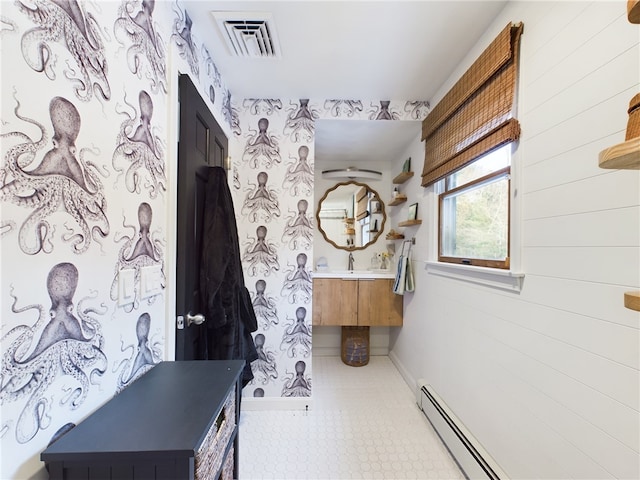 bathroom with wallpapered walls, baseboards, visible vents, baseboard heating, and vanity