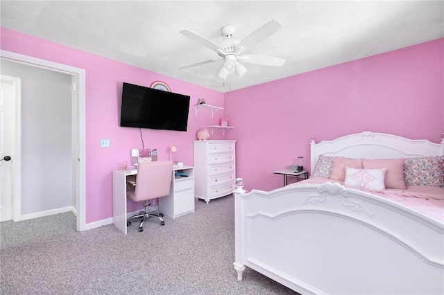 carpeted bedroom with ceiling fan and baseboards