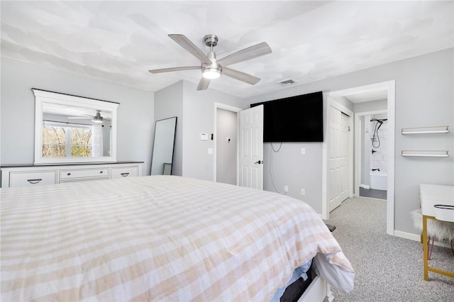 bedroom with ensuite bathroom, light colored carpet, a ceiling fan, baseboards, and visible vents